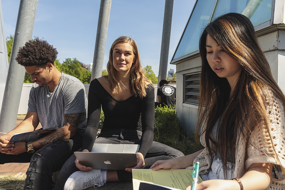 Three students studying outside