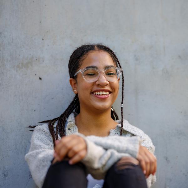 Student sitting against wall