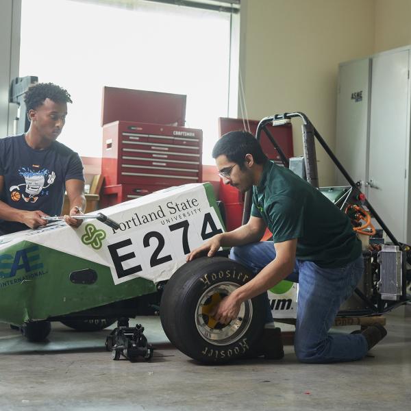 Engineering working on a car