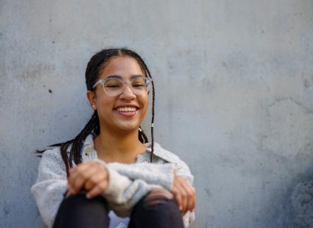 Student sitting against wall