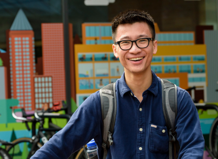 Student with his bike in front of the rec center