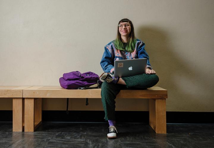 Student on her laptop in the hallway