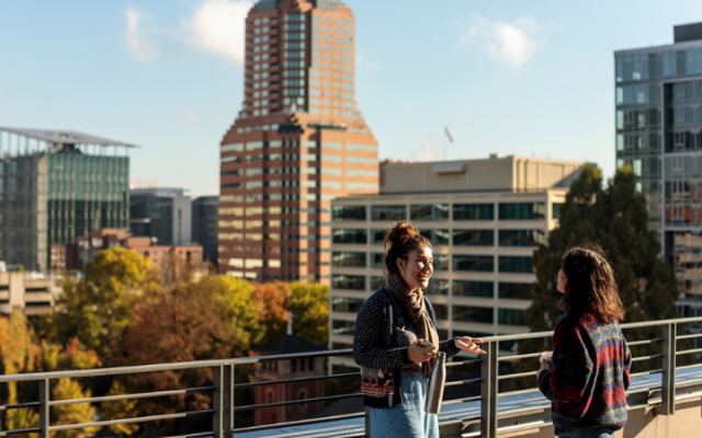 Students talking and looking out at Portland