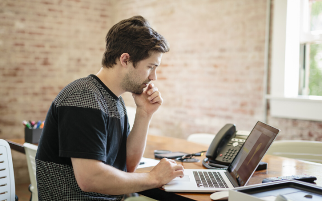 Student studying on his laptop