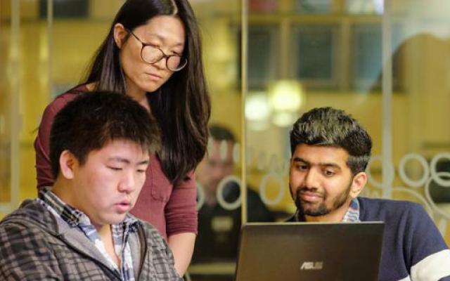 Computer science students working on a laptop
