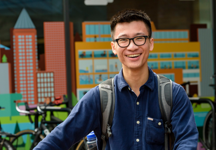 Student with his bike in front of the rec center