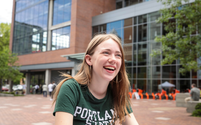 Student smiling in the Urban Plaza
