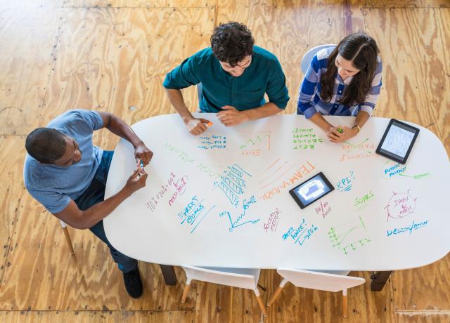 Aerial view of people meeting at a table.