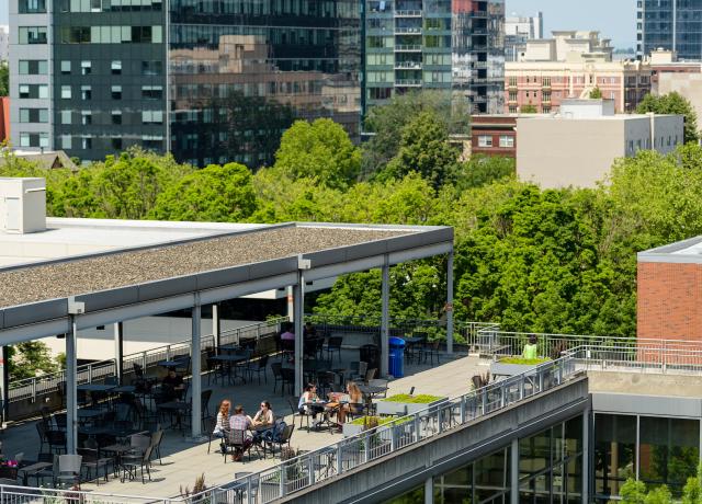 Aerial view of the rooftop of PSU's Urban Center with people at tables.