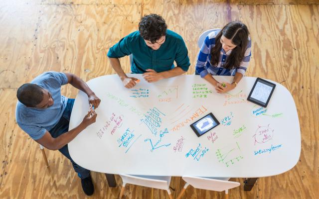 Aerial view of people meeting at a table.