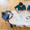 Aerial view of people meeting at a table.