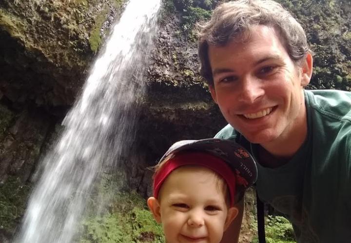 Picture of Dr. Hunt with son in front of waterfall