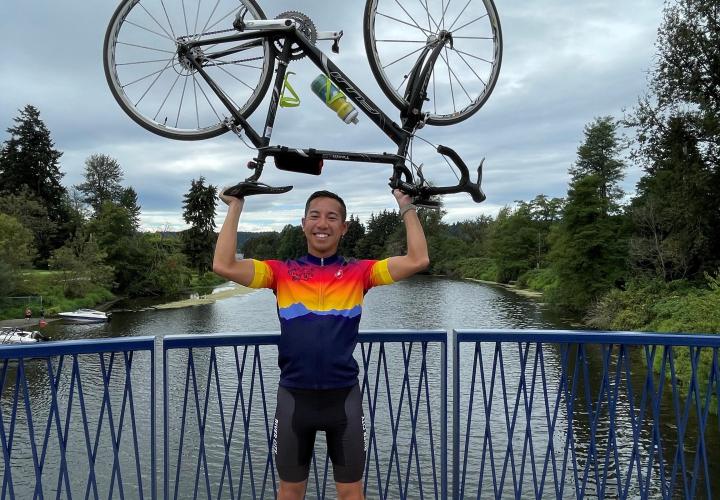 Picture of Jon proudly holding a bike