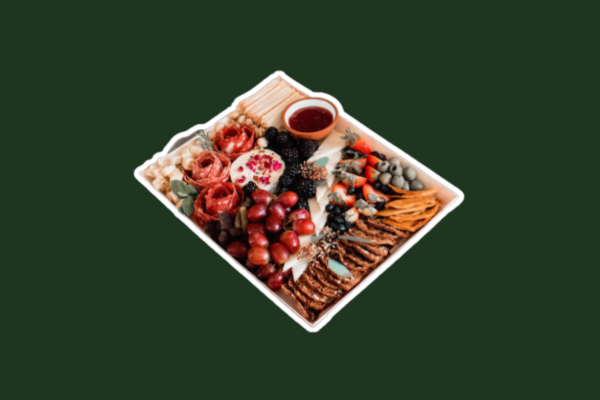 A charcuterie board with meats, cheeses, grapes, crackers and more.