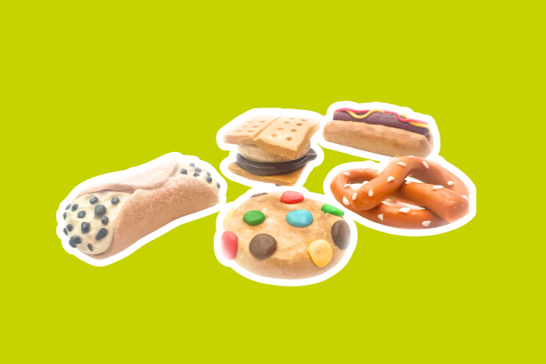 Magnets shaped like food items like a m&m cookie, pretzel, s'mores, hot dog and cannoli.