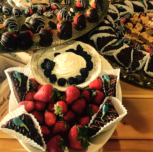 Display of desserts from chocolate strawberries to cookie bars.