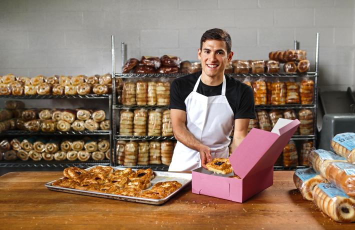 Man with bread at a bakery