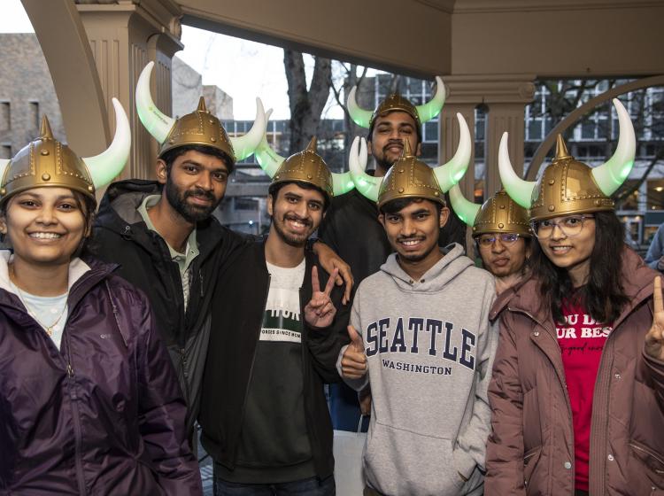 Group with matching light-up Viking helmets on outside the Simon Benson House.