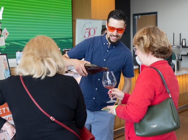 Pouring wine at the Winemaker's Tasting event.