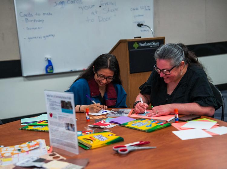 Volunteers at 2025 Serve the City Day decorating cards for seniors.