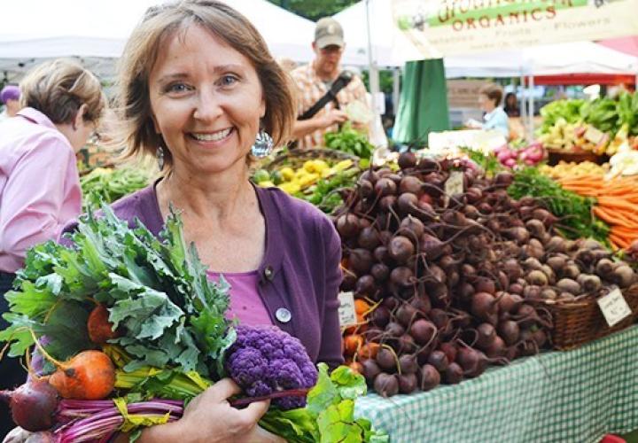 Trudy Toliver holding greens from the farmers market