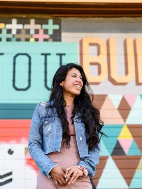Student in front of mural that says "You Build"