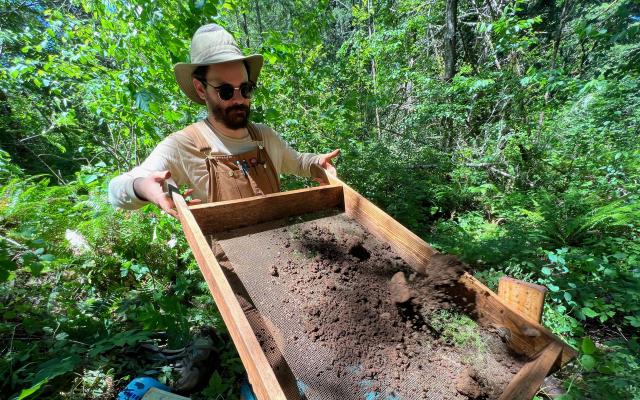 Student sifts through dirt