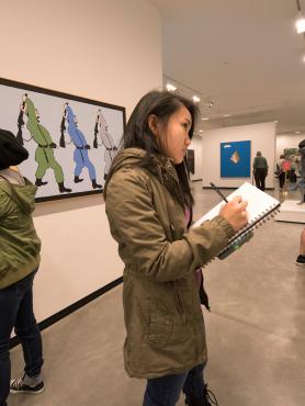 Students taking notes while viewing artwork at the Portland Art Museum