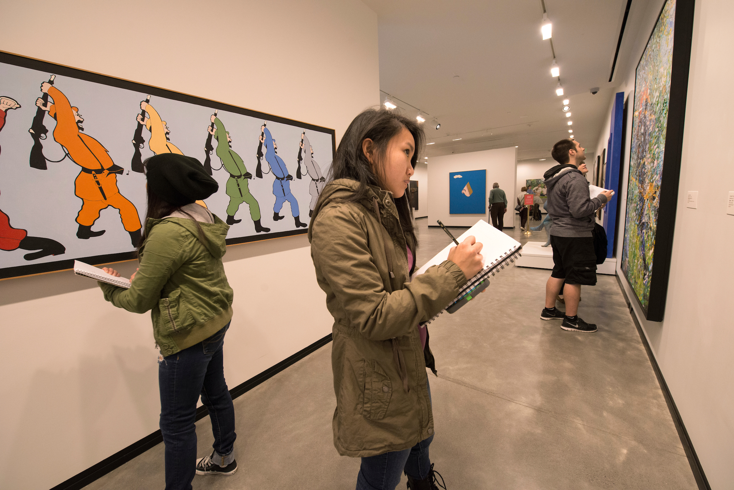 Students taking notes while viewing artwork at the Portland Art Museum