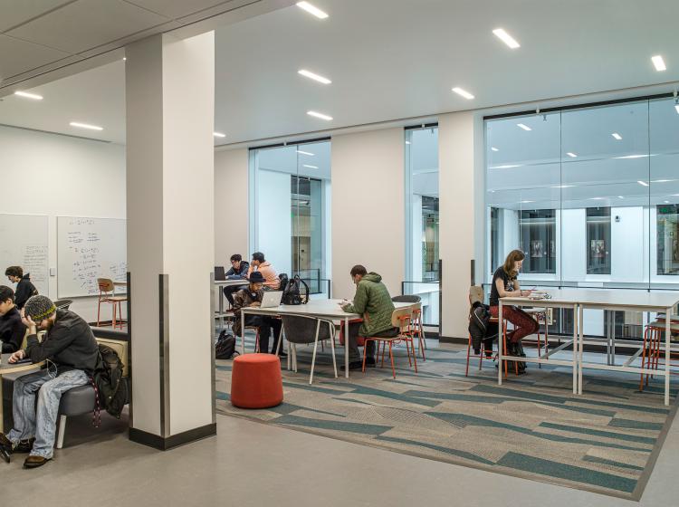 Students gathered at tables in student lounge