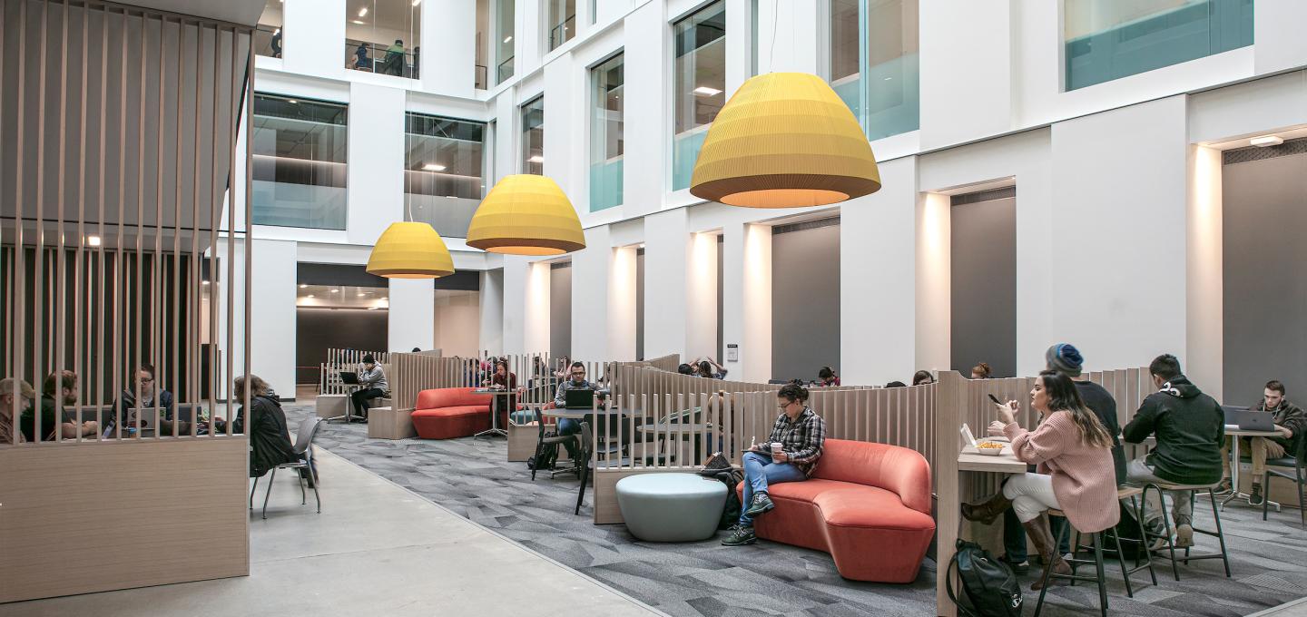 Student lounge viewed from basement level of Fariborz Maseeh Hall light well