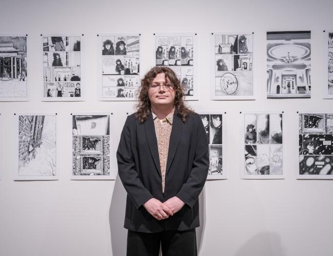 HG Garner posing in front of his artwork during the Schnitzer Prize exhibition.