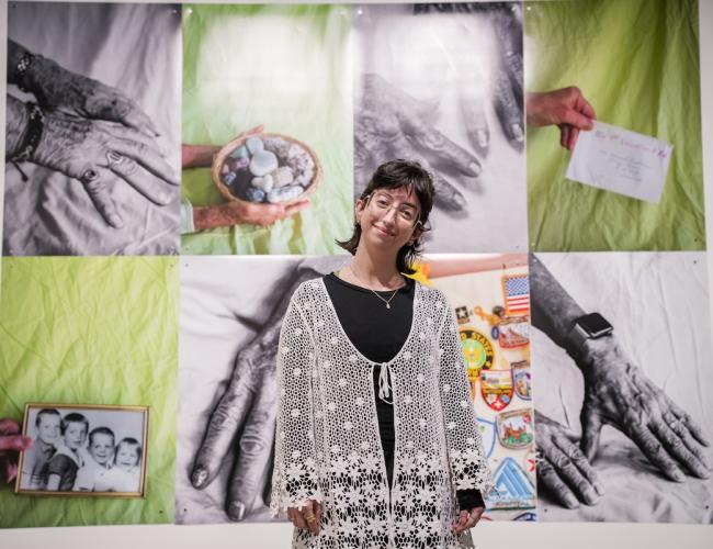 Olivia DelGandio standing in front of her instllation at the Schnitzer Prize exhibition.