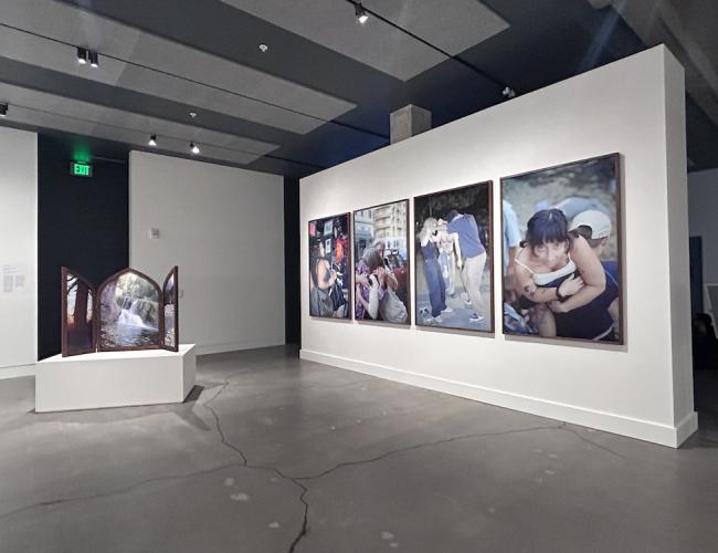 Installation view showing 4 large format photographs and one photographic work framed as a winged altarpiece.
