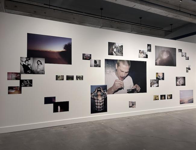 Grouping of photos by Savannah Noel scattered across a gallery wall in large and small format.