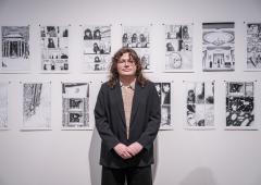 HG Garner posing in front of his artwork during the Schnitzer Prize exhibition.