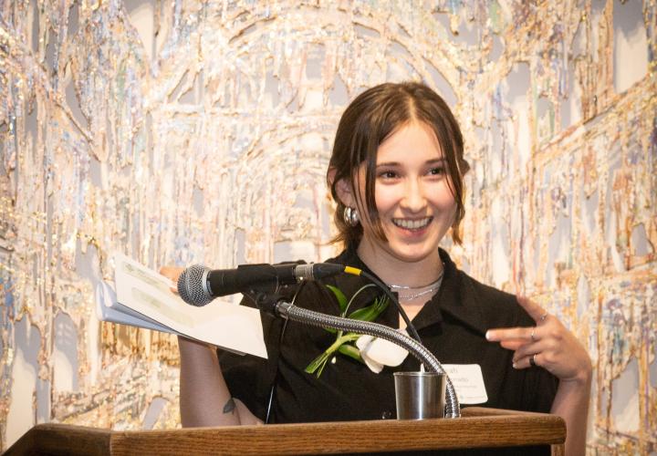 Woman at a podium making acceptance speech