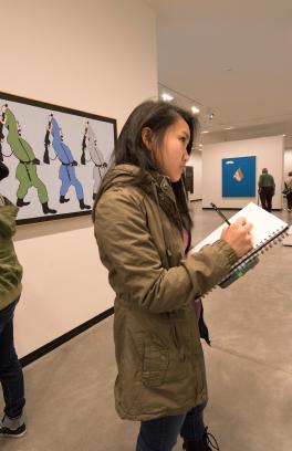 Students taking notes while viewing artwork at the Portland Art Museum