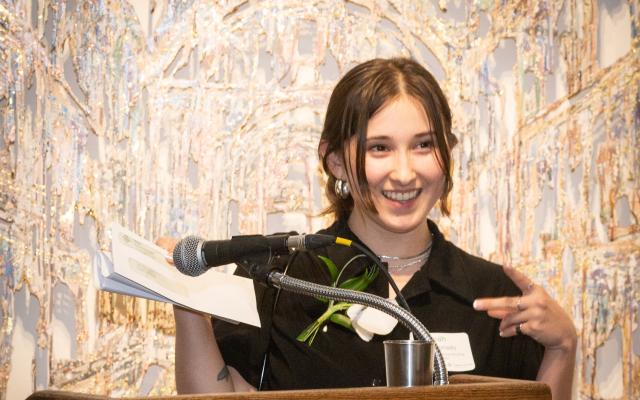 Woman at a podium making acceptance speech