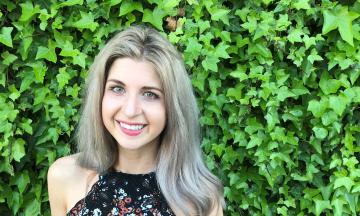 Emily Fox in front of an ivy covered wall