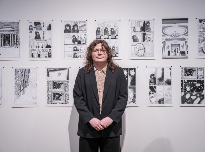 HG Garner posing in front of his artwork during the Schnitzer Prize exhibition.