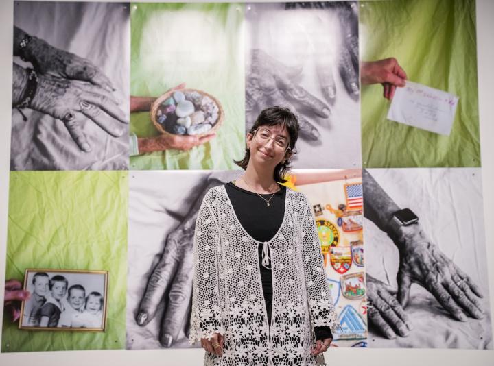 Olivia DelGandio standing in front of her instllation at the Schnitzer Prize exhibition.