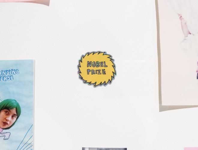 Yellow sticker thought bubble that says "Nobel Prize" in black.