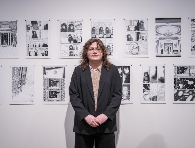 HG Garner posing in front of his artwork during the Schnitzer Prize exhibition.
