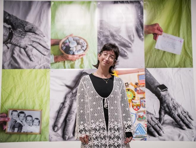 Olivia DelGandio standing in front of her instllation at the Schnitzer Prize exhibition.