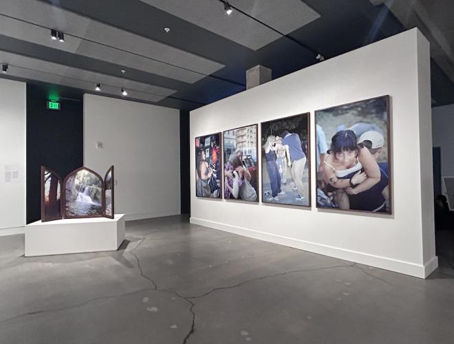 Installation view showing 4 large format photographs and one photographic work framed as a winged altarpiece.