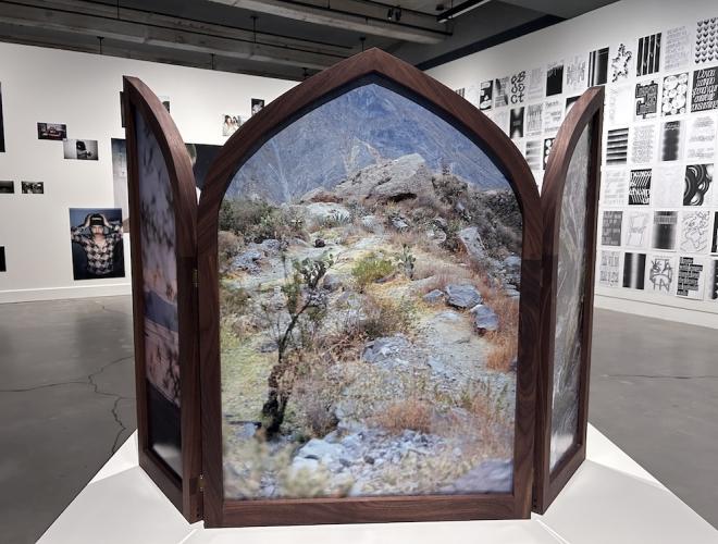 Landscape photographs framed in a winged altarpiece.