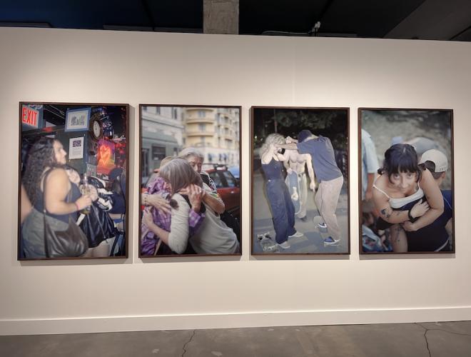 Four large format photographs together on a gallery wall.