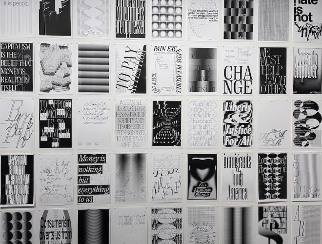 Detail view of black and white posters featuring uplifting messages and designs.