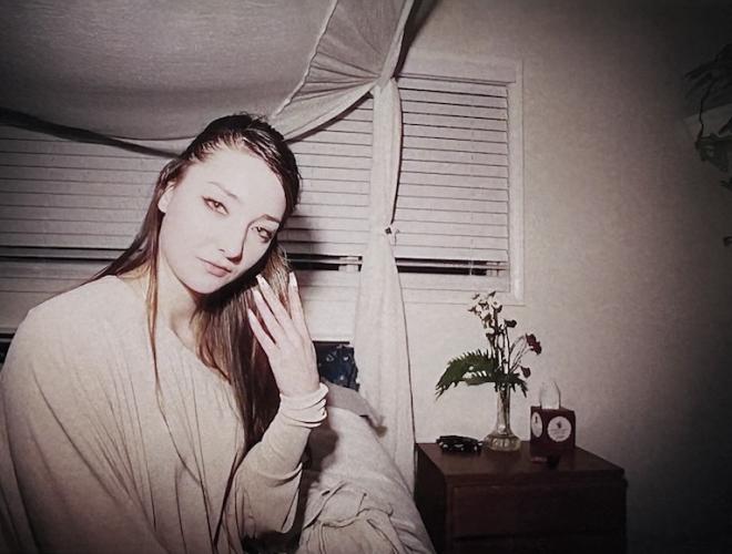 Photography by Savannah Noel featuring a woman with long hair in a white room.